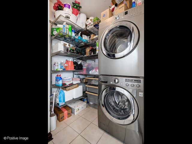 33 W Ontario St Unit 58E, Chicago, IL 60654 - laundry area featuring stacked washer / dryer and tile patterned floors