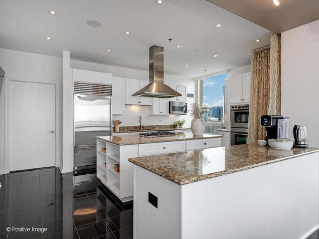 33 W Ontario St Unit 58E, Chicago, IL 60654 - kitchen featuring island range hood, appliances with stainless steel finishes, a kitchen island, white cabinets, and a sink