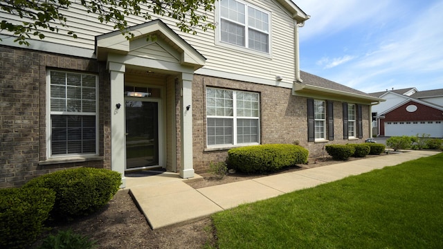 2620 Christie Dr, Algonquin, IL 60102 - view of exterior entry featuring brick siding and a yard