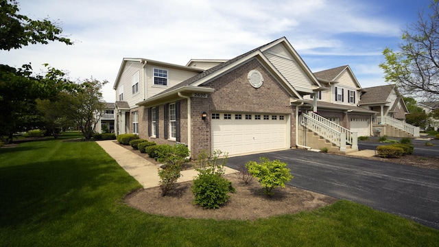 2620 Christie Dr, Algonquin, IL 60102 - view of front of home featuring asphalt driveway, brick siding, a garage, and a front yard