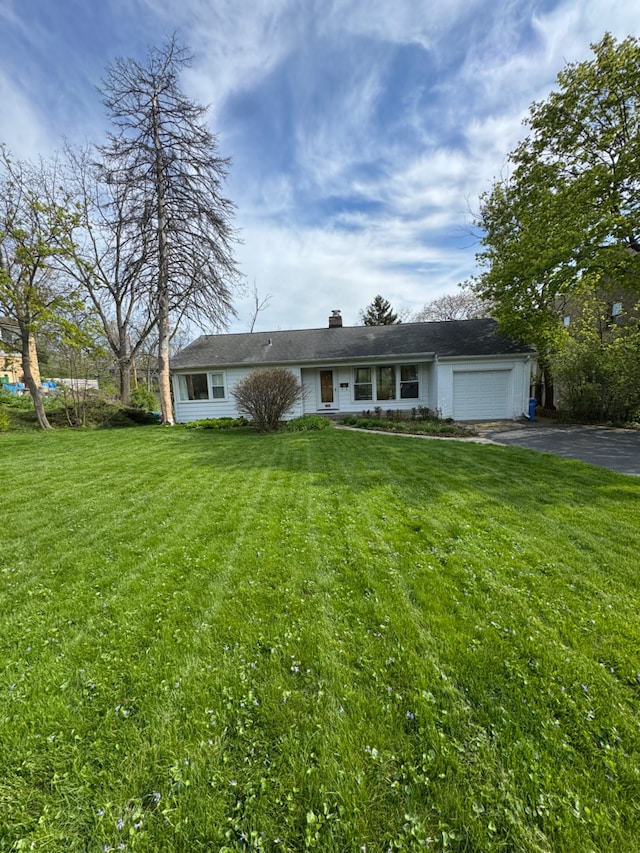 716 Marion Ave, Highland Park, IL 60035 - single story home featuring driveway, an attached garage, a front lawn, and a chimney