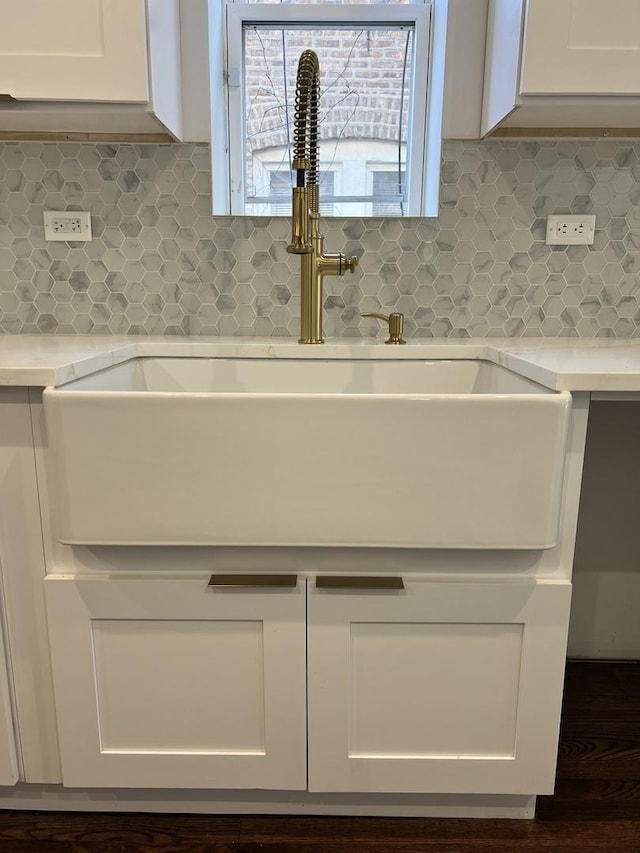 7317 S Maryland Ave, Chicago, IL 60619 - kitchen view of a sink, white cabinetry, light countertops, and tasteful backsplash