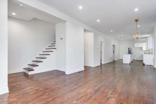 7317 S Maryland Ave, Chicago, IL 60619 - unfurnished living room with stairway, dark wood-style floors, baseboards, and recessed lighting