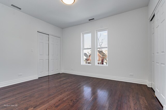 7317 S Maryland Ave, Chicago, IL 60619 - unfurnished bedroom featuring baseboards and dark wood-style floors