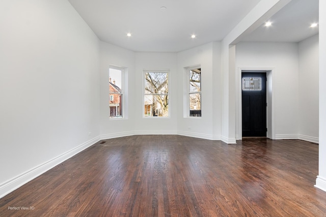 7317 S Maryland Ave, Chicago, IL 60619 - unfurnished living room with dark wood-style flooring, baseboards, and recessed lighting