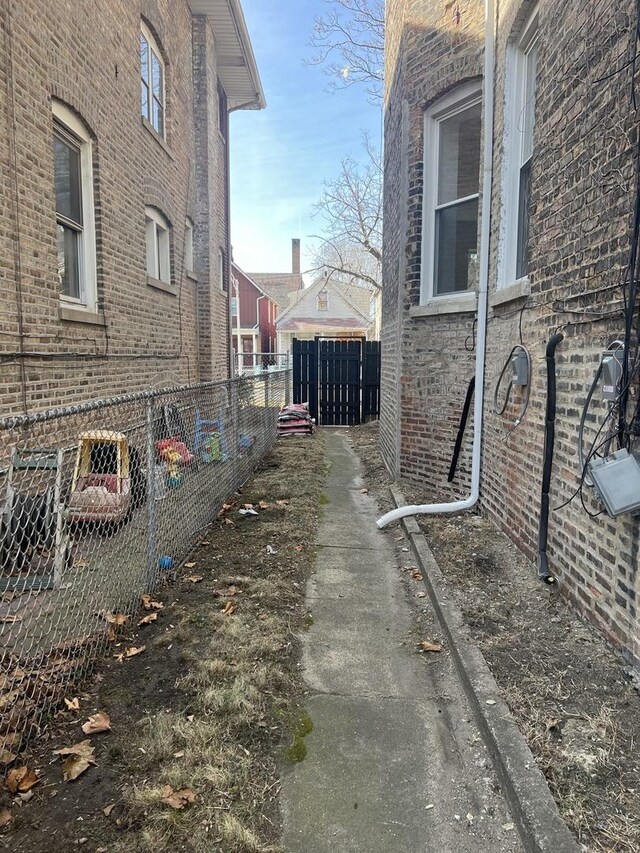 7317 S Maryland Ave, Chicago, IL 60619 - view of home's exterior featuring fence and brick siding