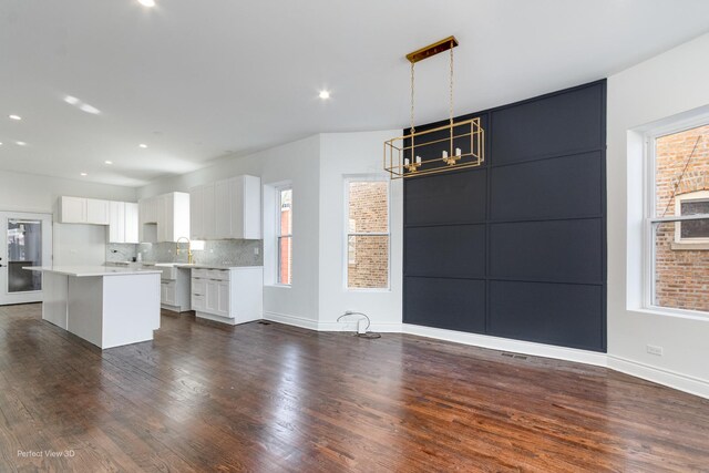 7317 S Maryland Ave, Chicago, IL 60619 - kitchen featuring dark wood-style flooring, light countertops, white cabinets, a center island, and recessed lighting