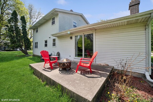 86 Brookside Dr, Elgin, IL 60123 - back of property with a fire pit, a yard, and a chimney