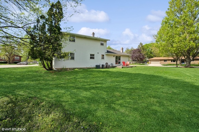 86 Brookside Dr, Elgin, IL 60123 - back of property featuring a yard, central AC unit, and a chimney