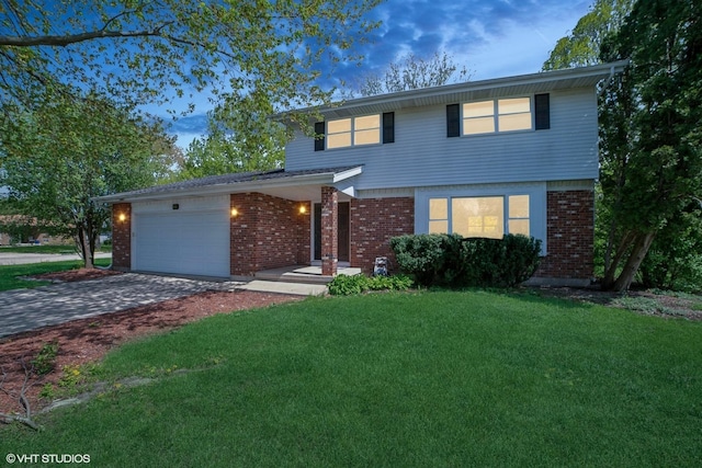86 Brookside Dr, Elgin, IL 60123 - traditional-style house featuring an attached garage, a front lawn, driveway, and brick siding