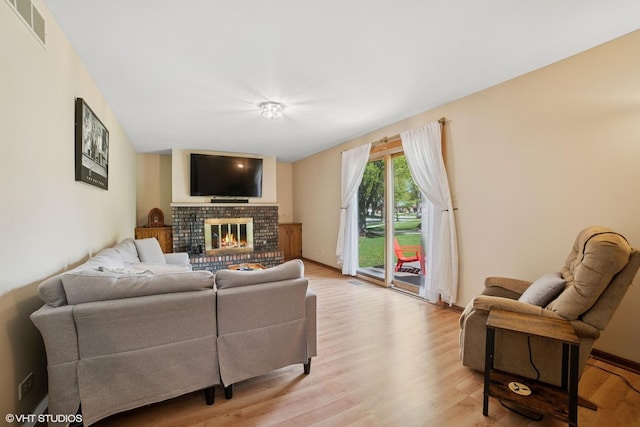 86 Brookside Dr, Elgin, IL 60123 - living room with light wood finished floors and a brick fireplace