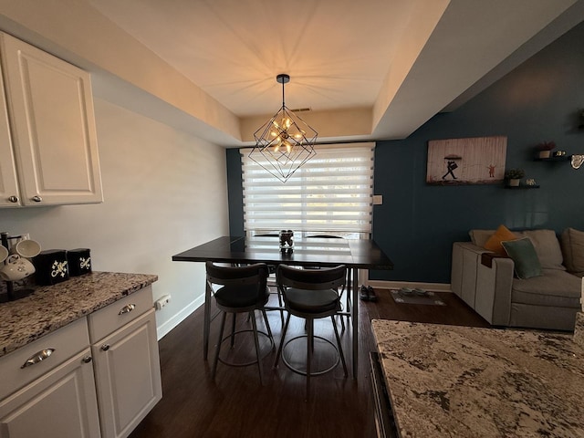 8223 170th St, Tinley Park, IL 60477 - dining area featuring baseboards, dark wood-style flooring, a chandelier, and a raised ceiling