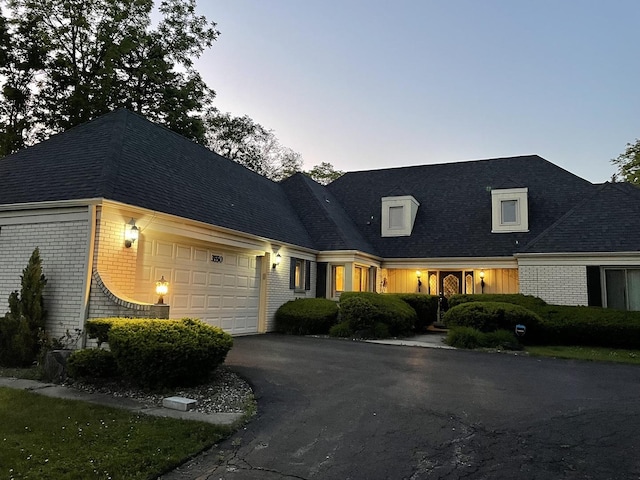 3550 Whirlaway Dr, Northbrook, IL 60062 - view of front of house with a garage, brick siding, and asphalt driveway
