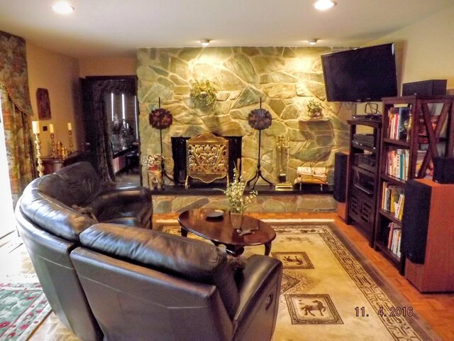 living area with a fireplace and recessed lighting