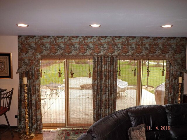 entryway featuring recessed lighting, wood finished floors, plenty of natural light, and baseboards