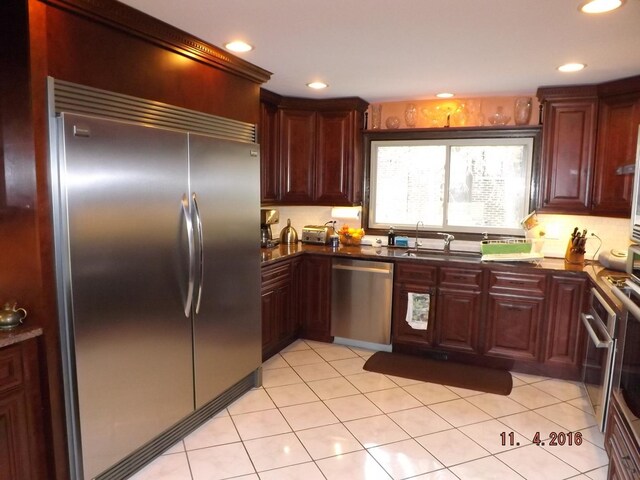 3550 Whirlaway Dr, Northbrook, IL 60062 - kitchen featuring appliances with stainless steel finishes, a sink, recessed lighting, dark brown cabinets, and light tile patterned floors