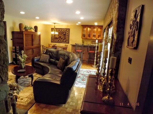 living area featuring recessed lighting and a chandelier