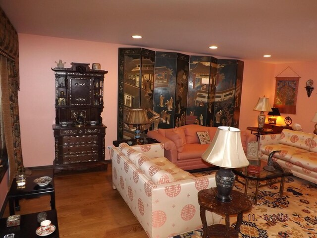 living area featuring wood finished floors and recessed lighting