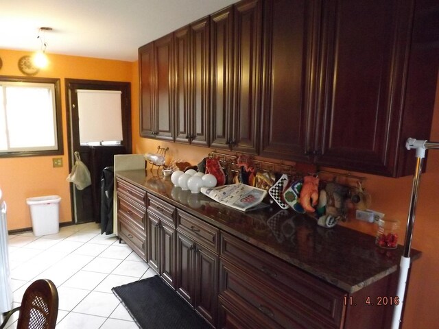 kitchen featuring light tile patterned floors and dark countertops