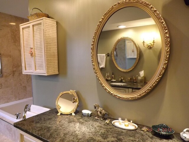 full bathroom with a bathtub and vanity