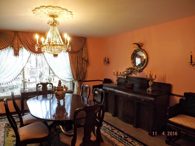 dining room featuring a chandelier and wood finished floors
