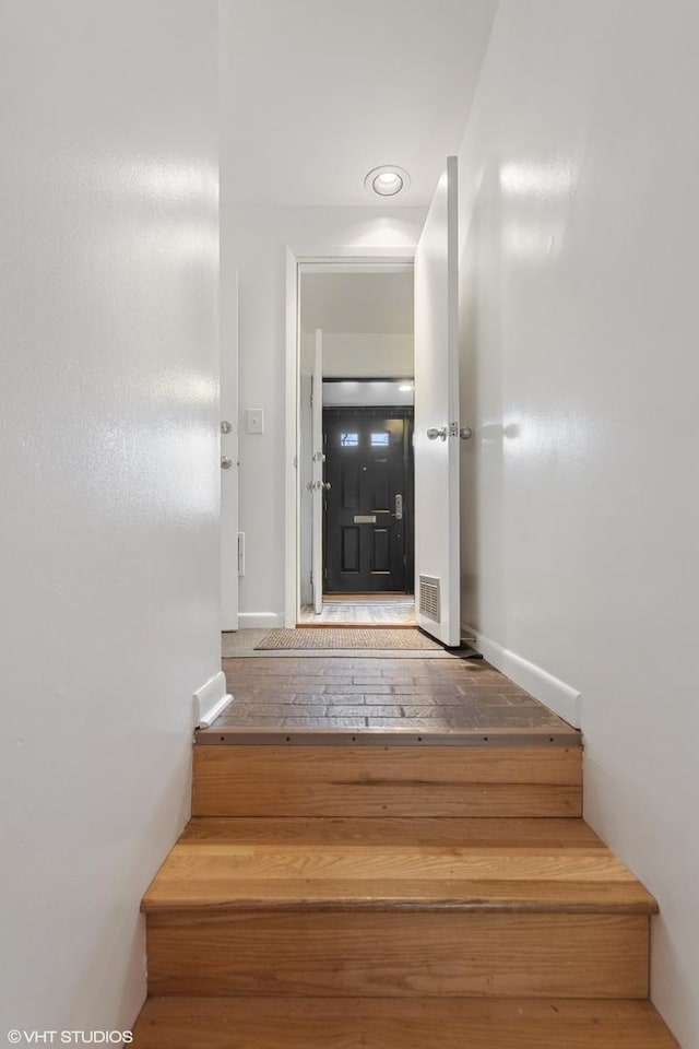 1747 N Fern Ct, Chicago, IL 60614 - staircase with baseboards and hardwood / wood-style floors