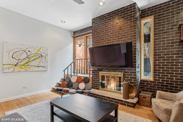 1747 N Fern Ct, Chicago, IL 60614 - living room featuring wood finished floors, a fireplace, baseboards, stairs, and ceiling fan