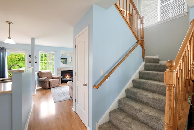 17 Ronan Ct, Lake In The Hills, IL 60156 - stairway featuring wood finished floors and a tile fireplace