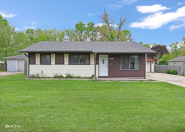 ranch-style house with a garage and an outbuilding