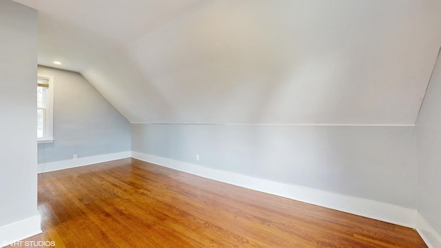 666 Greenview Ave, Des Plaines, IL 60016 - additional living space featuring vaulted ceiling, baseboards, and wood finished floors