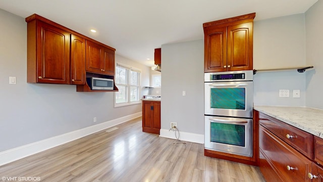 666 Greenview Ave, Des Plaines, IL 60016 - kitchen featuring appliances with stainless steel finishes, light wood-style flooring, baseboards, recessed lighting, and light stone counters