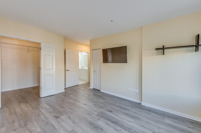 unfurnished bedroom featuring light wood-style floors and baseboards