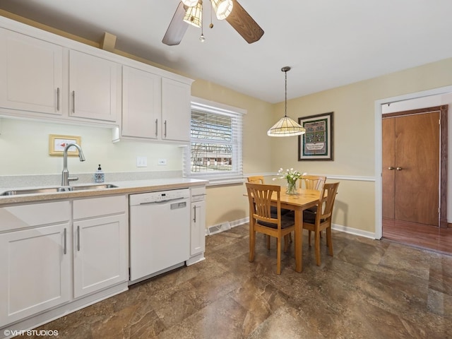 985 W Firestone Dr, Hoffman Estates, IL 60192 - kitchen with white dishwasher, a sink, stone finish flooring, a ceiling fan, and white cabinetry