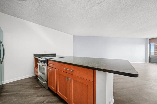 kitchen with stainless steel electric stove, baseboards, a textured ceiling, dark wood-style floors, and dark stone countertops