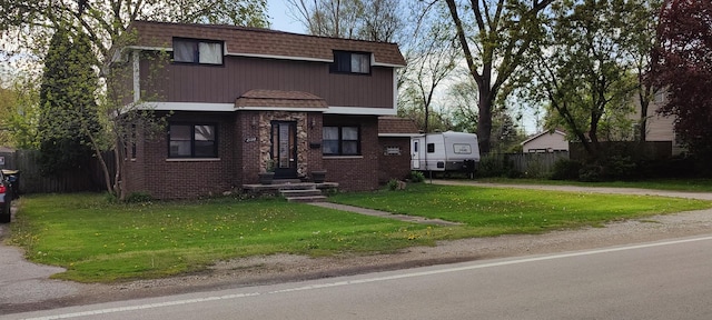 view of property featuring brick siding and mansard roof