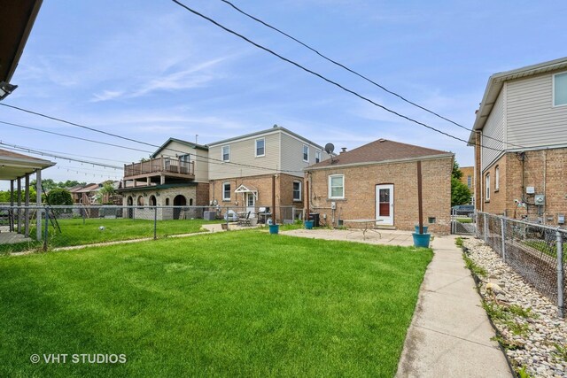 6119 S Melvina Ave, Chicago, IL 60638 - rear view of house featuring a patio area, a fenced backyard, and brick siding