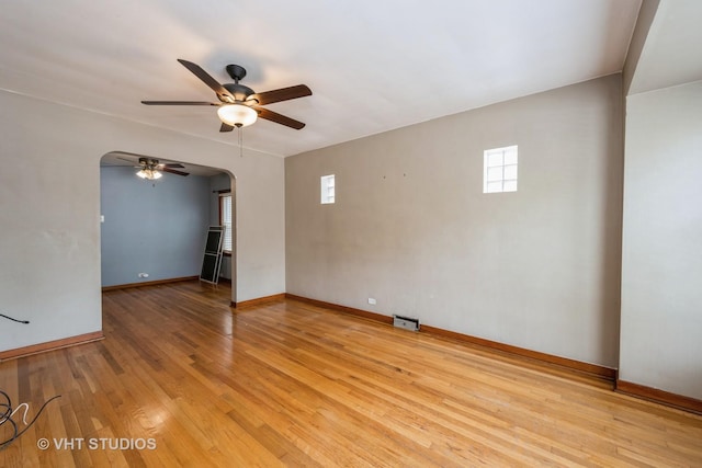 6119 S Melvina Ave, Chicago, IL 60638 - unfurnished room with arched walkways, a ceiling fan, and light wood-style flooring