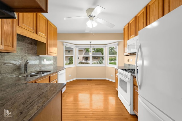 902 E Plate Dr, Palatine, IL 60074 - kitchen with white appliances, backsplash, light wood-type flooring, brown cabinetry, and dark stone countertops