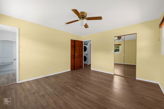 902 E Plate Dr, Palatine, IL 60074 - unfurnished bedroom with stacked washer and clothes dryer, dark wood-style floors, ensuite bathroom, and a ceiling fan