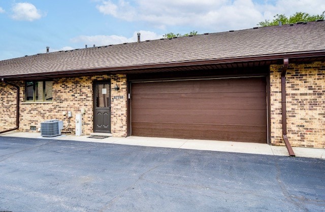 16052 Eagle Ridge Dr, Tinley Park, IL 60477 - single story home featuring brick siding, an attached garage, a shingled roof, and asphalt driveway
