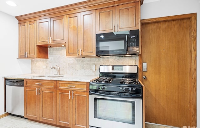 16052 Eagle Ridge Dr, Tinley Park, IL 60477 - kitchen featuring appliances with stainless steel finishes, a sink, decorative backsplash, and light stone counters