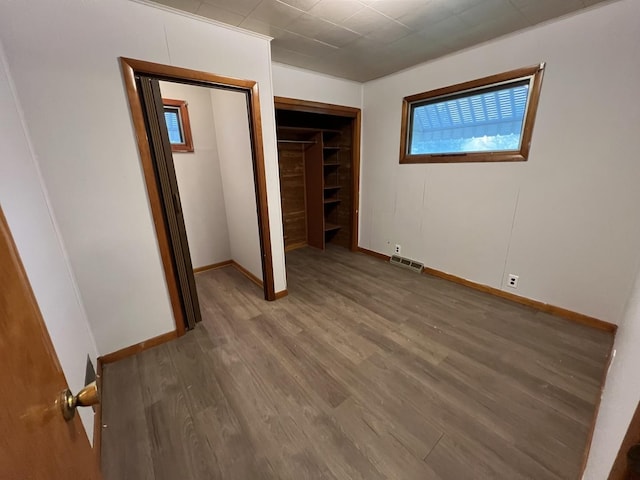 1112 1st Ave, Ottawa, IL 61350 - unfurnished bedroom featuring wood finished floors, baseboards, and a closet