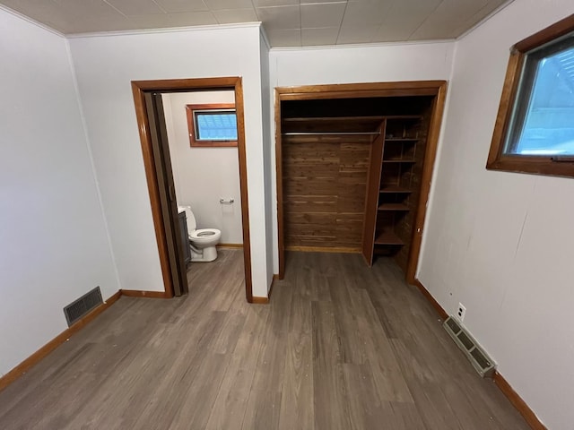 1112 1st Ave, Ottawa, IL 61350 - unfurnished bedroom with wood finished floors, baseboards, and a closet