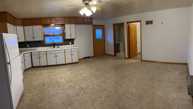 1112 1st Ave, Ottawa, IL 61350 - kitchen featuring freestanding refrigerator, a sink, light countertops, ceiling fan, and white cabinets