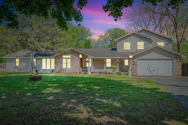 25647 W Old Grand Ave, Ingleside, IL 60041 - view of front of home with asphalt driveway, an attached garage, a lawn, a porch, and stone siding