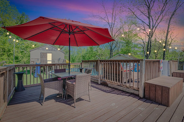 25647 W Old Grand Ave, Ingleside, IL 60041 - wooden deck featuring outdoor dining space, an outbuilding, and a storage unit