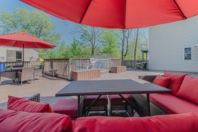 25647 W Old Grand Ave, Ingleside, IL 60041 - wooden deck featuring outdoor dining area, outdoor lounge area, an outdoor structure, and a storage shed