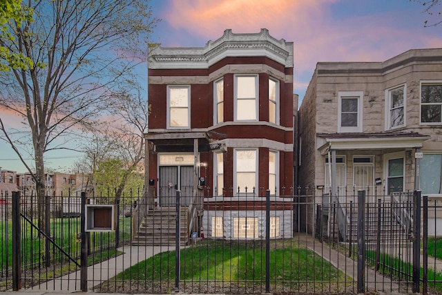7223 S Union Ave, Chicago, IL 60621 - view of front of home with a fenced front yard, a gate, and stone siding
