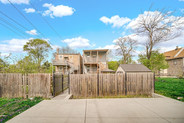 7223 S Union Ave, Chicago, IL 60621 - view of front of house featuring a fenced front yard, a gate, stairway, and a balcony