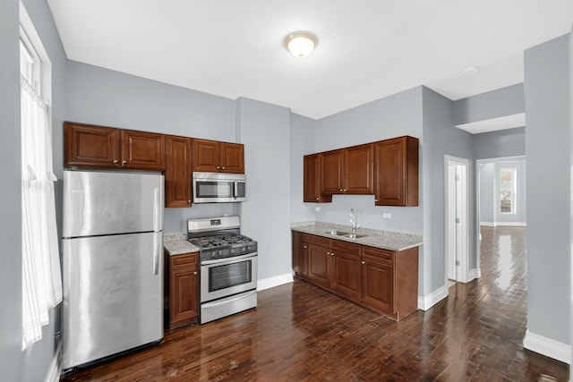 7223 S Union Ave, Chicago, IL 60621 - kitchen with stainless steel appliances, a sink, baseboards, and light stone countertops